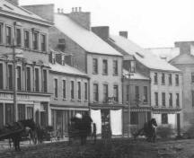 Detail of a historic photo of Water Street, St. John's, showing Yellow Belly Corner at the right of the photo, the last building in the row. Date unknown.; City of St. John's Archives photo number 04-21-014, copyright 2006.