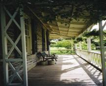 View of the verandah on the north side of house showing bell-cast slope of the roof - 2003; OHT - 2003