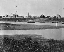 Historic view of Moose Factory showing the HBC Staff House (dark coloured building at left) - 1870; Archives of Canada, 2006