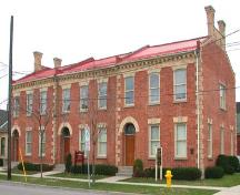 East facing façade featuring round-headed entrance portals, and brick cornice, 2003.; Department of Planning, City of Brantford, 2003.