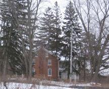 Contextual photograph of the Schoerg Homestead depicting the heavily treed landscape, 2007.; Lindsay Benjamin, 2007.