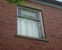 Stained glass window and patterned brick detail, Acadia Lodge, Pugwash, NS, 2007.; Heritage Division, NS Dept. of Tourism, Culture and Heritage, 2007