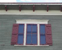 This photograph shows one of three triple set windows and the roof-line cornice ornamented with modillions, 2005; City of Saint John