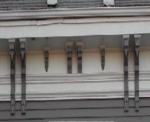 This image provides a view of the wood cornice supported by a series of paired and single brackets, 2006; City of Saint John