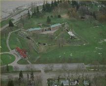 Aerial view of Fort Erie, showing its setting on a flat grassed parcel of land overlooking Lake Erie at the mouth of the Niagara River, 1991.; Parks Canada Agency / Agence Parcs Canada, 1991.
