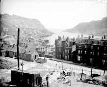 Historic photo of Devon House (near middle) taken pre-1892 fire; view at background of the photo shows the St. John's Narrows and Signal Hill.; Government of Canada Collections 2006