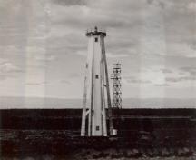 General view of the Light Tower, showing the tall massing of the hexagonal structure with a lantern platform.; Parks Canada Agency / Agence Parcs Canada.