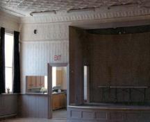 Interior view of the Former Pickering Town Hall, showing details such as the wood wainscoting and tin-embossed paneling, 2005.; Public Works and Government Services Canada / Travaux publics et Services gouvernementaux Canada, 2005.