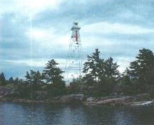 General view of the Rear Range Light Tower, showing its slender, tapered prefabricated skeletal steel frame.; Canadian Coast Guard / Garde côtière canadienne.