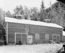 View of the Gas House, showing the large double doors with horseshoe hinges, 1988.; Parks Canada Agency / Agence Parcs Canada, 1988.