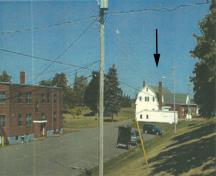 Panoramic view of the Cereal Forage Building (right) and Building 10 (left) showing the compatible scale, materials and style vis-a-vis the remaining adjacent buildings on the farm, 2001.; Agriculture and Agri-Business Canada \ Agriculture et Agroalimentaire Canada, 2001.