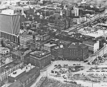 Historic image of an aerial view over the Halifax Waterfront Buildings emphasizing the spatial relationship of the buildings to each other and to the harbour.; Parks Canada Agency / Agence Parcs Canada, n.d.