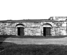 Front facade of the North Front Casemate showing the simple composition of a central door flanked by two side windows, 1989.; Parks Canada Agency / Agence Parcs Canada, 1989.