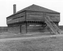 General view of Blockhouse 3, showing the squared logs with dovetailed corners, the loopholes, small windows and entrances on both levels, ca. 1989.; Parks Canada Agency / Agence Parcs Canada, ca. 1989.