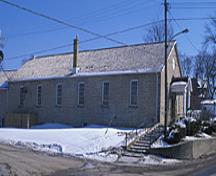 Side view of the Former Elora Drill Shed, showing its regularly placed multi-pane sash windows and stone construction, 1995.; Parks Canada Agency / Agence Parcs Canada, J. Butterill, 1995.