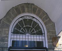 Detail view of the Former Elora Drill Shed, showing the oculus above the central entry, 1995.; Parks Canada Agency / Agence Parcs Canada, J. Butterill, 1995.