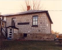 General view of the east façade of the Defensible Lockmaster’s House, 1987.; Parks Canada Agency / Agence Parcs Canada, 1987.