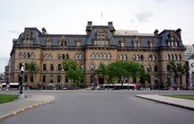 General view of the Office of the Prime Minister and Privy Council, showing its Second Empire style, evident in its high mansard roof punctuated by one- and two-storey dormers, which emphasize the three-dimensional quality of the silhouette.; Parks Canada Agency / Agence Parcs Canada.