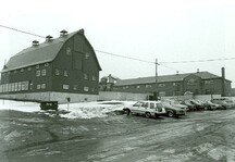 Rear view of the Small Dairy Barn, showing the numerous large windows, and square roof turrets, 1987.; Parks Canada Agency / Agence Parcs Canada, 1987.