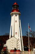 General view of the Light Tower, showing the tower's six flying buttresses, 1987.; Canadian Coast Guard / Garde côtière canadienne, 1987.