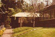 General view of the the Superintendent’s Residence and Works Garage showing the modest massing of the T-shaped building.; Parks Canada | Parcs Canada, n.d.