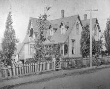 This photo depicts the Gothic Revival architecture of the residence prior to the additon of stone and other Classical details in 1883.  This photo was most likely taken when the builder, R. C. Donald, resided at this location.; Moncton Museum