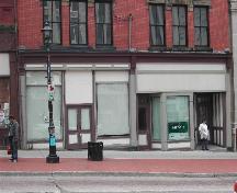 This photograph shows the three entrance storefront, columns and storefront cornice, 2004; City of Saint John