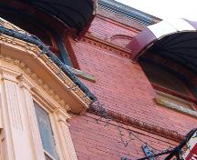 203 Water Street, detail of trims, dentil, egg and dart and sawtooth; also showing hooded canopies over arched windows.  Photo taken July 12, 2006; HFNL/ Deborah O'Rielly 2006.