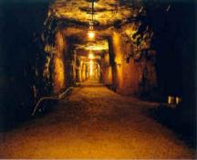 Looking down the mine shaft of the No. 2 Mine.  Note the hand carved sides and the installed lighting.  This shaft slopes at a grade of 10 percent.; No. 2 Mine and Museum, 2006
