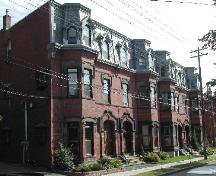 This photograph shows the contextual view of the building and the three other buildings that comprise the entire complex. The Lorenzo Crosby Residence is the portion of the complex in the foreground of the image.; City of Saint John