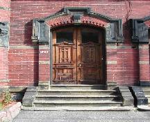 This photograph shows the elaborate entrance and prominent wooden door, 2004; City of Saint John