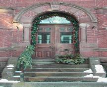 This image shows the Roman arched entry including a brick and stone entablature, 2006.; City of Saint John