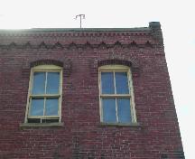This photograph shows the roof-line cornice with corbel bands and dentils, 2005; City of Saint John