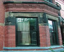 This image provides a view of the first storey bay windows with decorative lintels, 2005.; City of Saint John