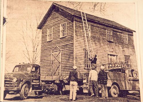 Historic image of the house being relocated - 1964