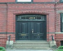 This image the segmented arch entrance over the wooden doors, 2005.; City of Saint John