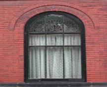 This image shows the Roman arch window, 2005.; City of Saint John