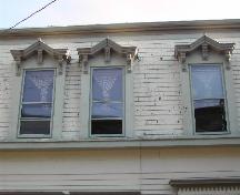 This photograph shows the gable dormer windows with bracketed entablatures, 2005.; City of Saint John