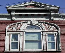 This image provides a view of the elaborate pediment, the cornice and the central Palladian window, 2005.; City of Saint John