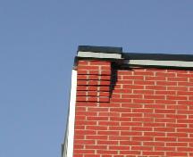 This image provides a view of a brick corbelled bracket supporting the cornice at the building's corner, 2005. ; City of Saint John
