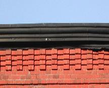 This image provides a view of the cornice ornamented by brick corbel bands, 2005.; City of Saint John