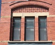 This photograph shows the triple window under a segmented arch, 2005.; City of Saint John
