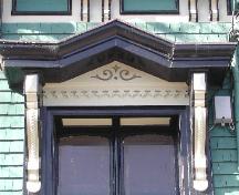 This photograph shows the ornate entablature over the entrance and rope design in the brackets, 2005; City of Saint John