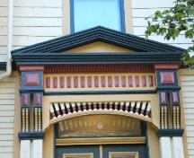 This photograph shows the pediment over the entrance, the ornate brackets and decorative frieze band, 2005; City of Saint John