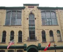 This photograph shows the unique characteristics of the building such as the Roman arch windows and large segmented arch windows, 2005; City of Saint John