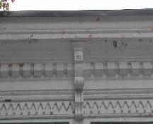 This image provides a view of the cornice ornamented by dentils,  decorative woodwork and wooden brackets, 2005; City of Saint John