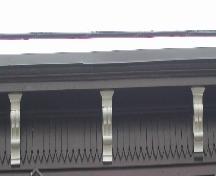 This image provides a view of the cornice ornamented with pointed woodwork and supported by ornate scrolled brackets, 2005; City of Saint John