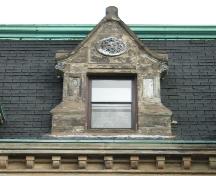 This image provides a view of the pedimented dormer ornamented with a lion's face medallion, 2005; City of Saint John