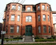 This photograph shows a contextual view of the building on Orange Street, 2005.; City of Saint John