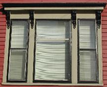 Cette image montre les fenêtres triples avec entablement soutenu par quatre consoles décoratives en volute, 2005; City of Saint John
